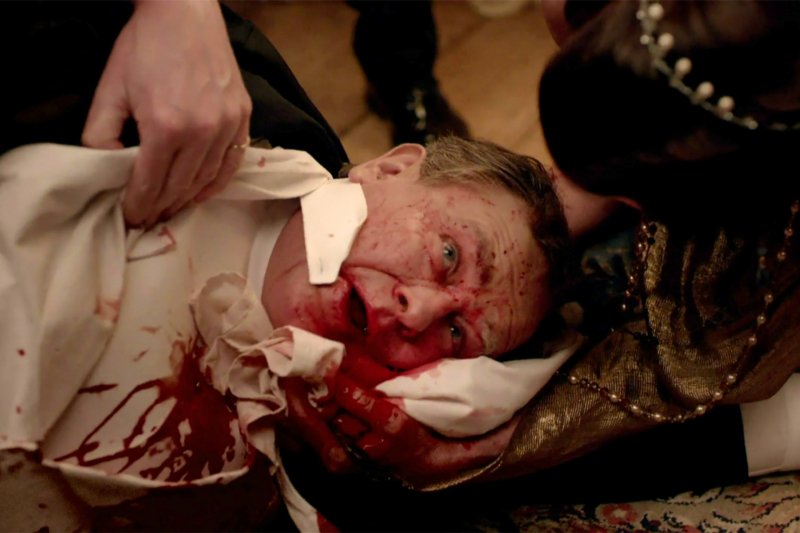 Lord Grantham vomits blood over the dinner table after suffering from a burst ulcer in a scene from Downton Abbey